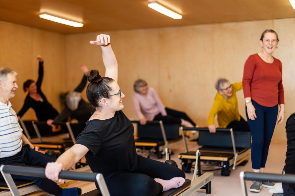 Joyful group reformer class at Upside Pilates