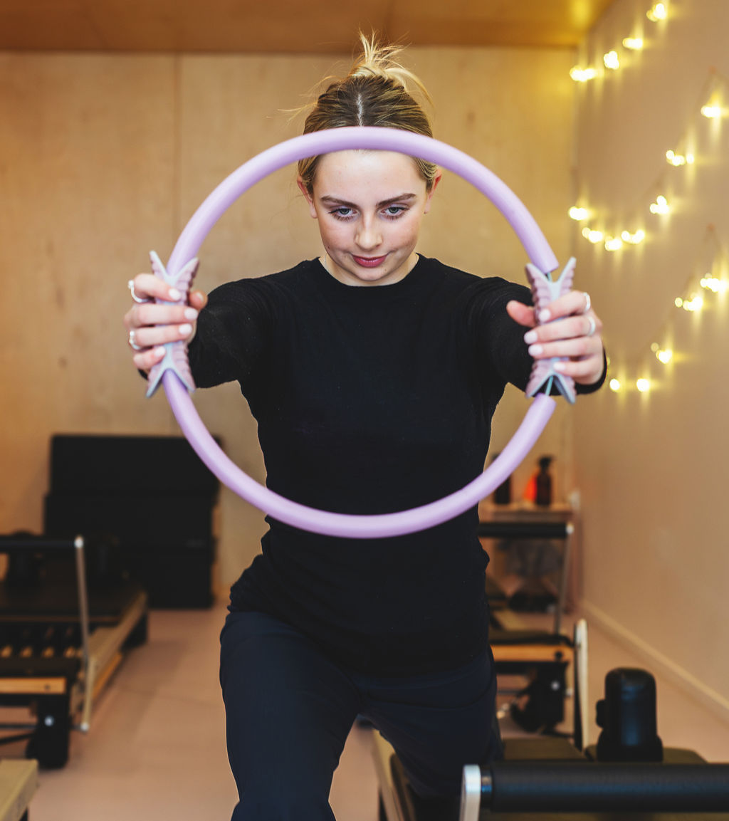 Client working with a Pilates magic circle